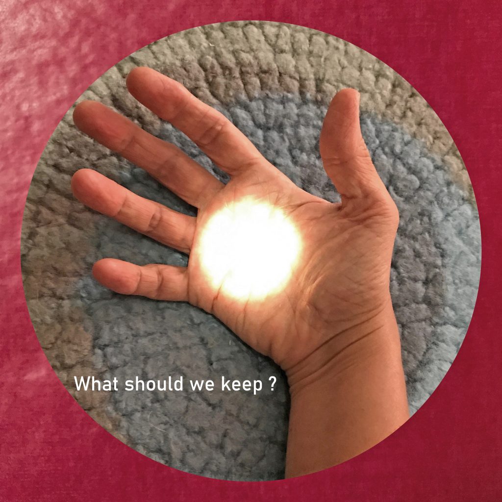 “what should we keep“ written in white on an image of an open hand, palm up, in a blue and grey circle inside a red square. In the center of the palm is a white circle of light.
